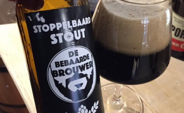 stoppelbaard stout van de bebaarde brouwer bier in glas